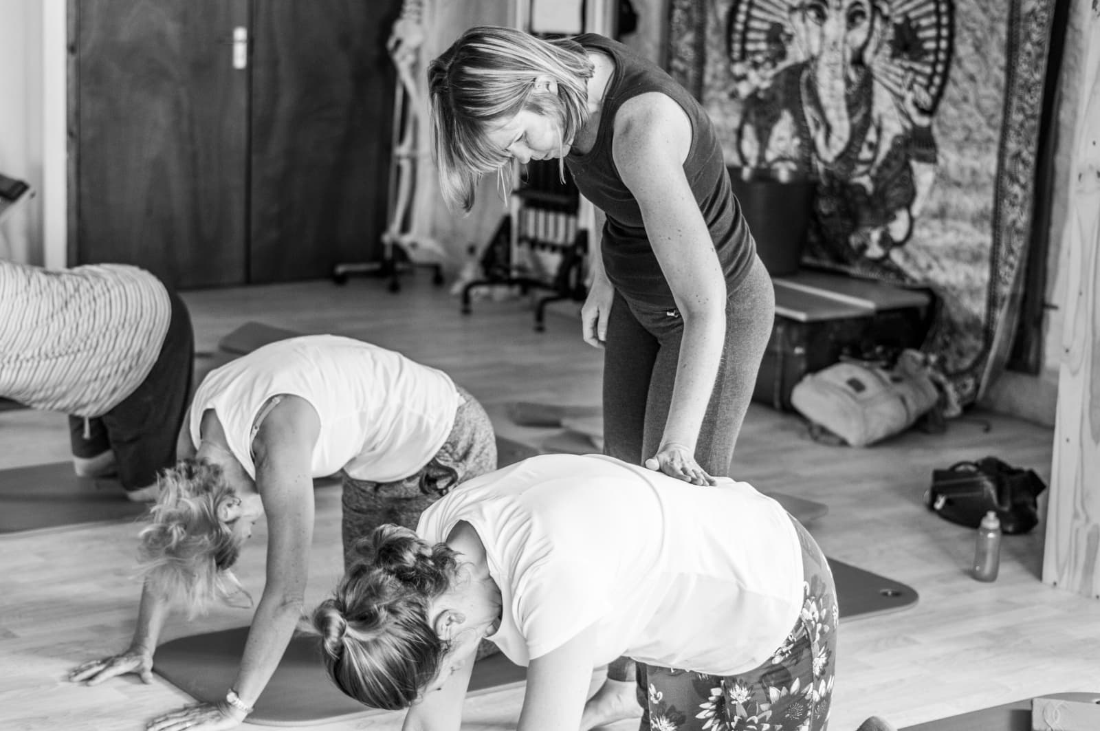 Debbie providing hands-on guidance during a Pilates class